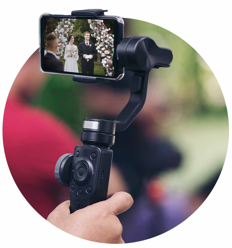 Phone on small gimbal with wedding on screen.