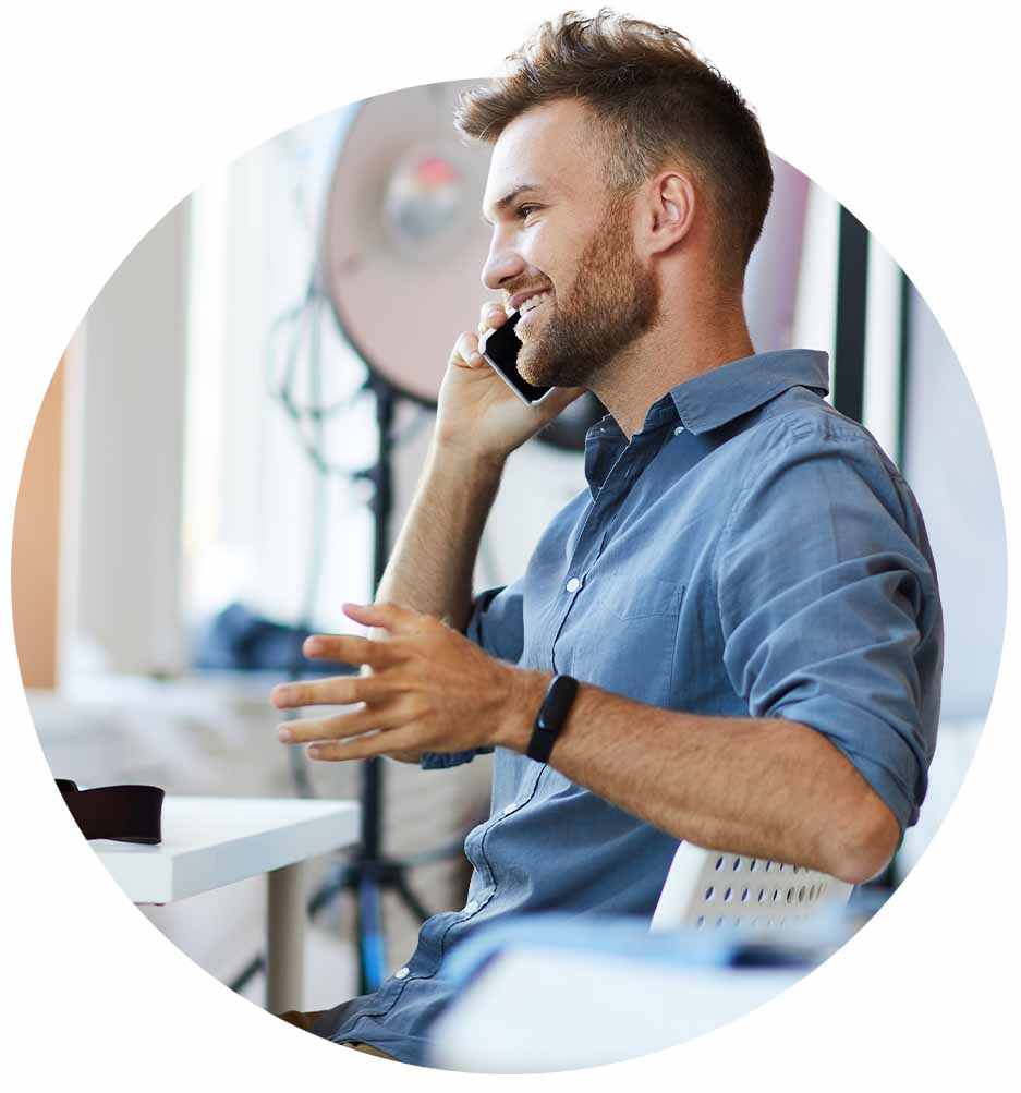 Person smiling while talking on phone.