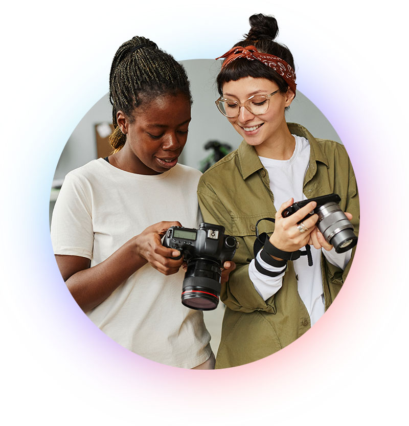 Two photographers reviewing their work on a camera.